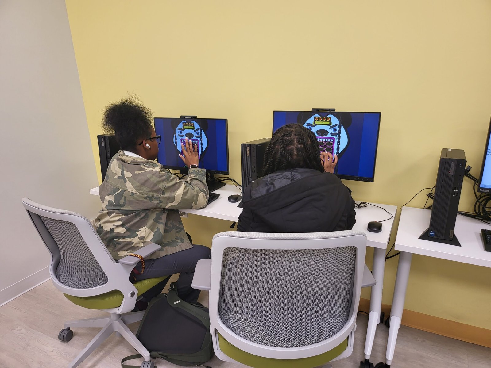 Two students are working on a game